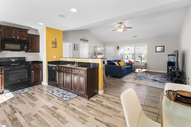 122 Barred Owl Dr, Fountain Inn, SC 29644 - kitchen featuring a sink, open floor plan, a peninsula, black appliances, and vaulted ceiling