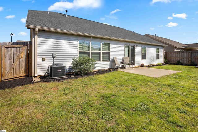 122 Barred Owl Dr, Fountain Inn, SC 29644 - back of property with roof with shingles, central air condition unit, a patio area, a yard, and fence