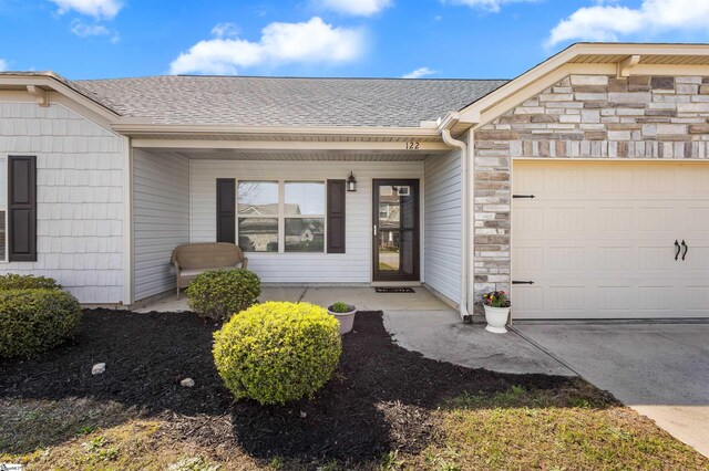 122 Barred Owl Dr, Fountain Inn, SC 29644 - entrance to property featuring a porch, a shingled roof, a garage, and stone siding