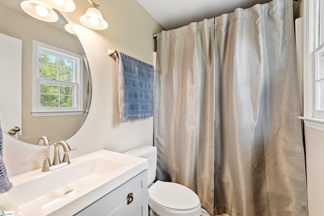bathroom featuring toilet, curtained shower, and vanity