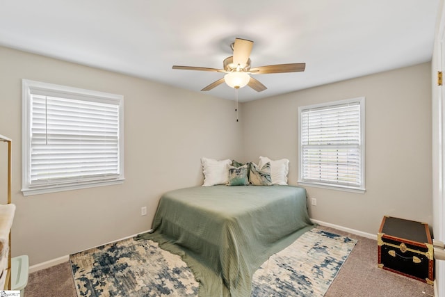 carpeted bedroom with baseboards and ceiling fan