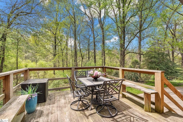 wooden terrace with outdoor dining space