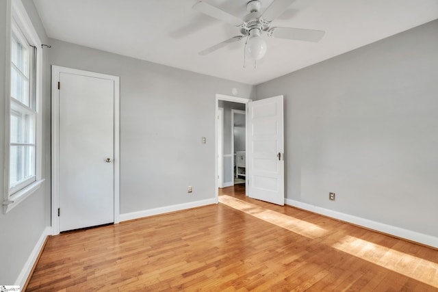 unfurnished bedroom featuring baseboards, ceiling fan, and light wood-style floors