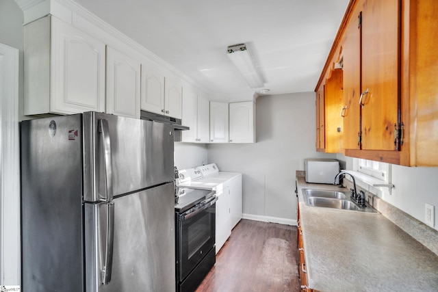 kitchen with black range with electric cooktop, a sink, freestanding refrigerator, dark wood-style floors, and washing machine and clothes dryer