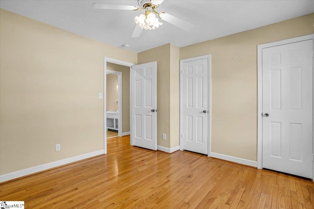 unfurnished bedroom with baseboards, light wood finished floors, and a ceiling fan
