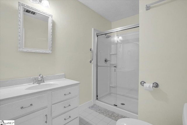 full bath with vanity, tile patterned flooring, visible vents, toilet, and a stall shower