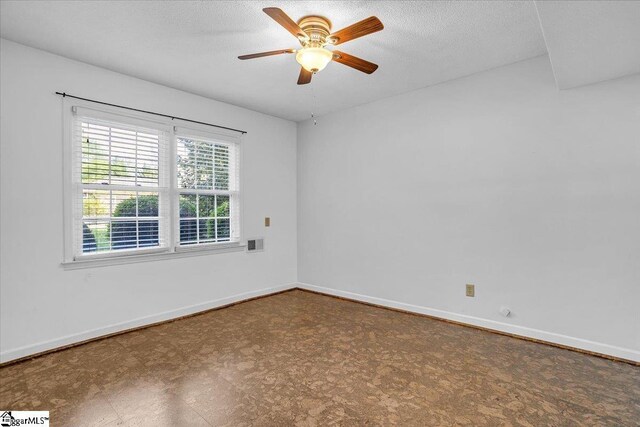 spare room featuring baseboards, tile patterned floors, a textured ceiling, a ceiling fan, and visible vents