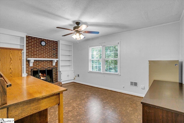 interior space featuring tile patterned floors, a ceiling fan, visible vents, and a textured ceiling