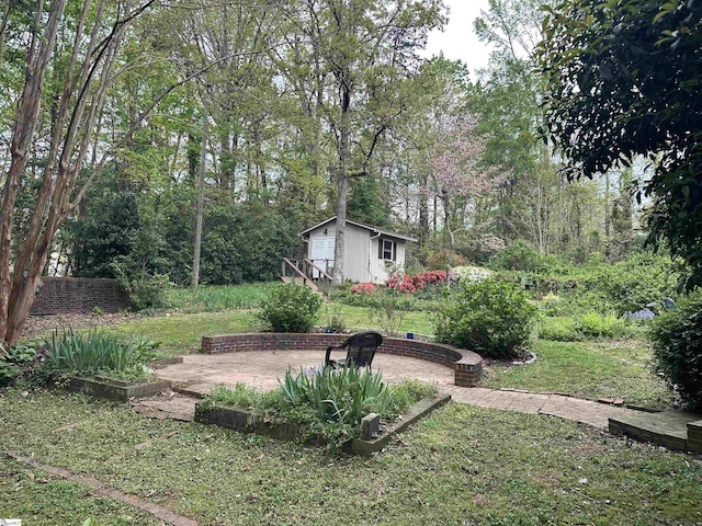 view of yard with an outdoor structure and a patio