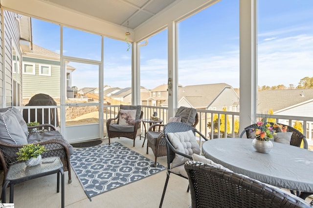 sunroom featuring a residential view