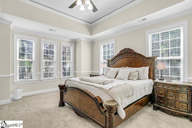 bedroom with crown molding, baseboards, multiple windows, and light colored carpet