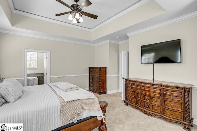 bedroom with ensuite bath, light colored carpet, crown molding, and a raised ceiling