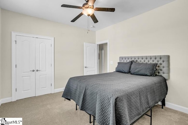bedroom with a closet, baseboards, and carpet floors