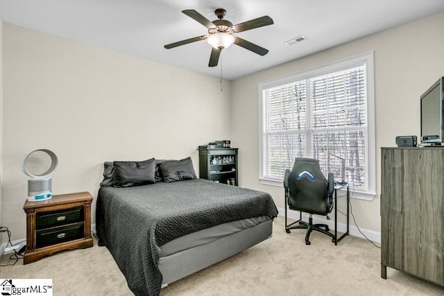 bedroom with carpet, visible vents, baseboards, and ceiling fan