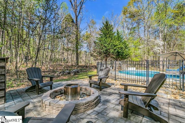view of patio / terrace featuring a fenced in pool, fence, and an outdoor fire pit