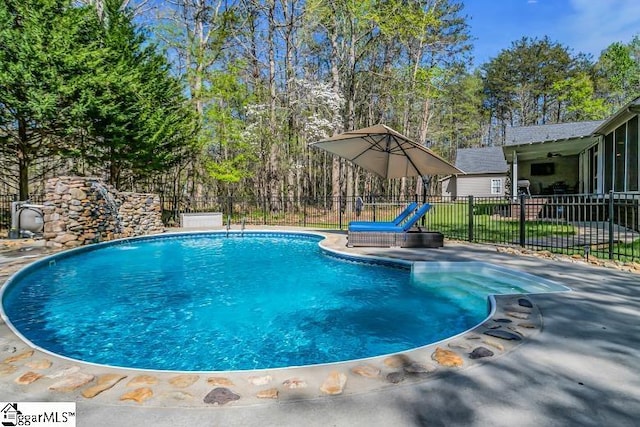 view of pool with a fenced in pool and fence