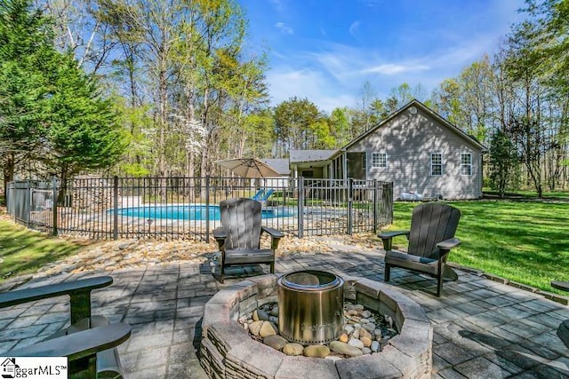 view of patio / terrace with a fenced in pool, fence, and a fire pit