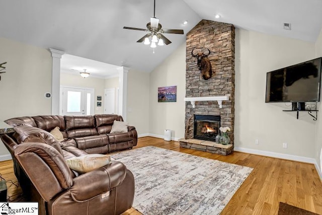 living area with ornate columns, a ceiling fan, visible vents, wood finished floors, and baseboards