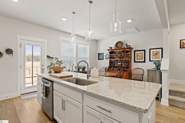 17 Starlake Rd, Simpsonville, SC 29681 - kitchen featuring light wood-style floors, white cabinetry, dishwasher, a sink, and a center island with sink