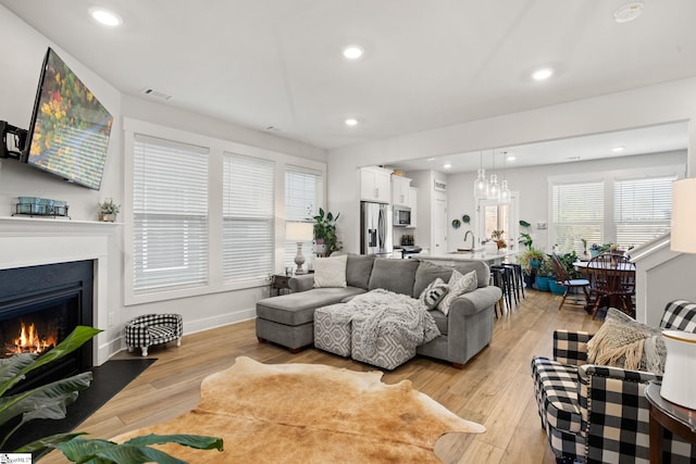 17 Starlake Rd, Simpsonville, SC 29681 - living area featuring visible vents, recessed lighting, light wood-type flooring, and a fireplace with flush hearth