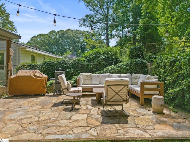 view of patio with outdoor lounge area, a grill, and fence