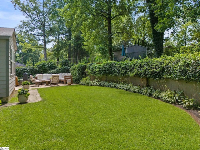 view of yard featuring a patio area, a fenced backyard, and an outdoor living space
