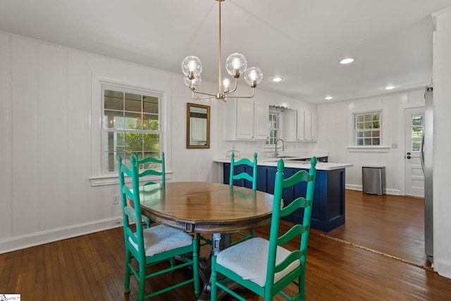 dining room featuring a chandelier, dark wood-style flooring, and a wealth of natural light