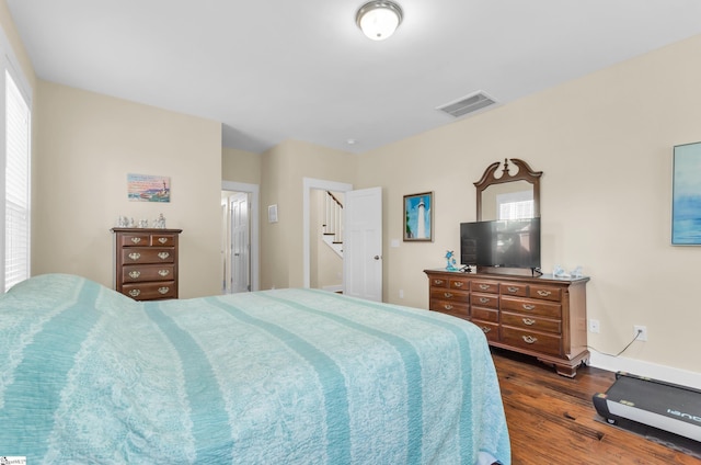 bedroom featuring dark wood-type flooring and visible vents