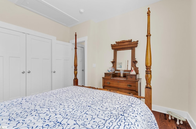 bedroom featuring baseboards, dark wood-type flooring, a closet, and attic access