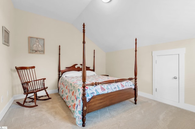 bedroom featuring baseboards, light carpet, and lofted ceiling