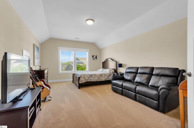 carpeted bedroom with baseboards and lofted ceiling