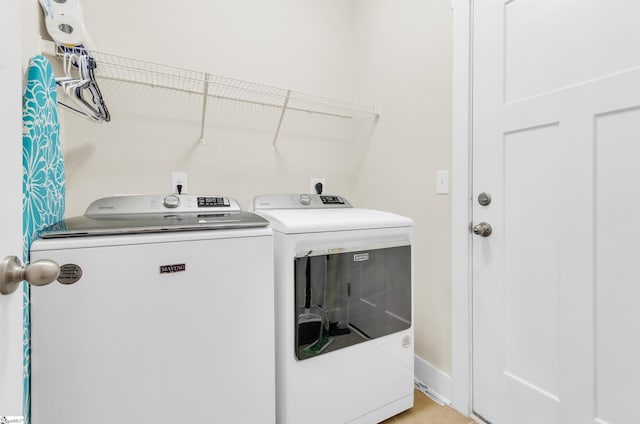 washroom with washer and clothes dryer and laundry area
