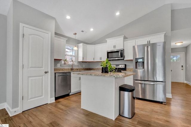 kitchen with light wood-style floors, appliances with stainless steel finishes, white cabinetry, and visible vents