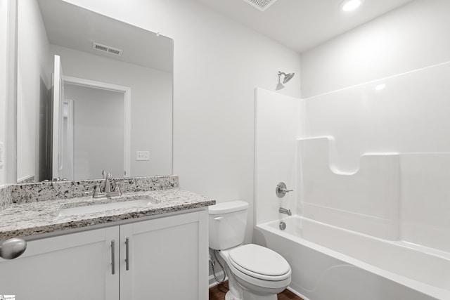 bathroom featuring shower / bathtub combination, vanity, visible vents, and toilet