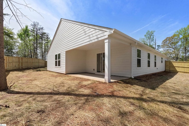 rear view of house featuring a patio area and a fenced backyard