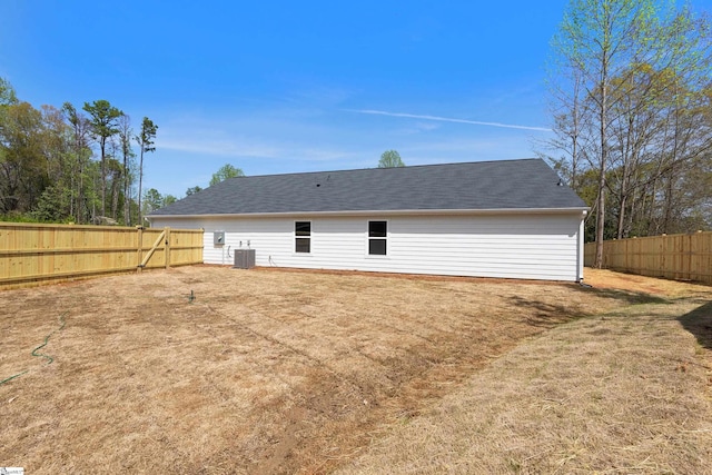 rear view of property featuring cooling unit and a fenced backyard