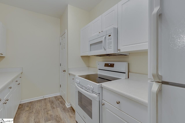 kitchen featuring white appliances, light wood-style flooring, white cabinets, light countertops, and baseboards