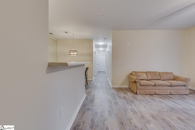 living room featuring baseboards and wood finished floors