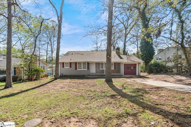 ranch-style house with an attached garage, driveway, and a front lawn