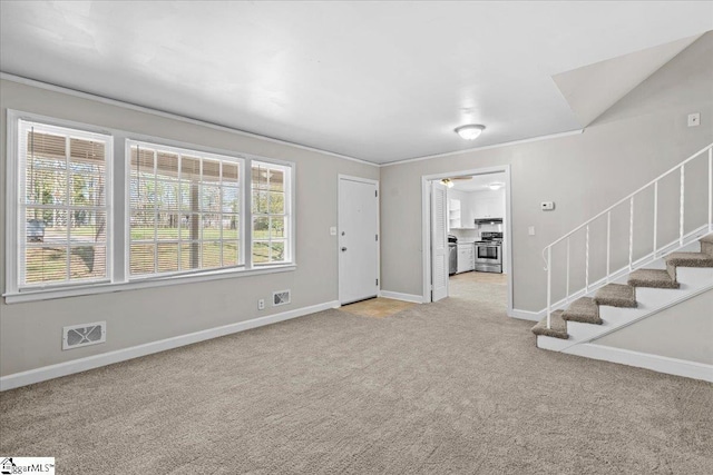 unfurnished living room featuring crown molding, visible vents, light carpet, stairs, and baseboards