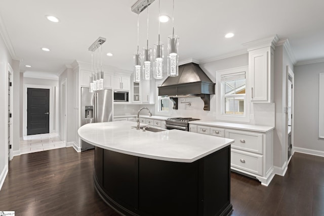 kitchen featuring dark wood-style flooring, premium range hood, light countertops, appliances with stainless steel finishes, and a sink