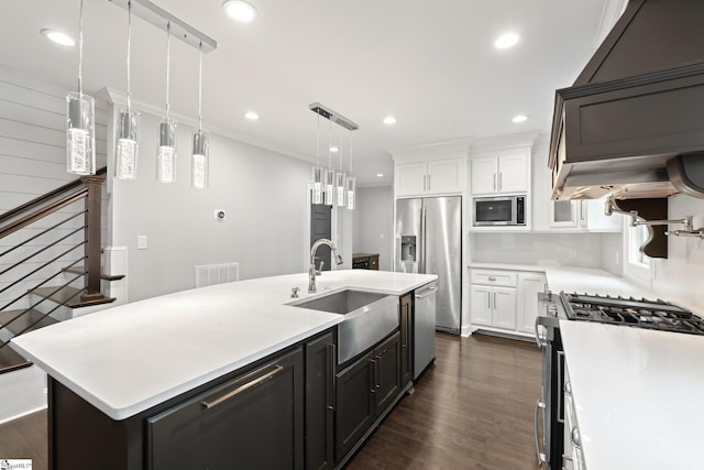 kitchen with dark wood-style flooring, light countertops, visible vents, appliances with stainless steel finishes, and a sink
