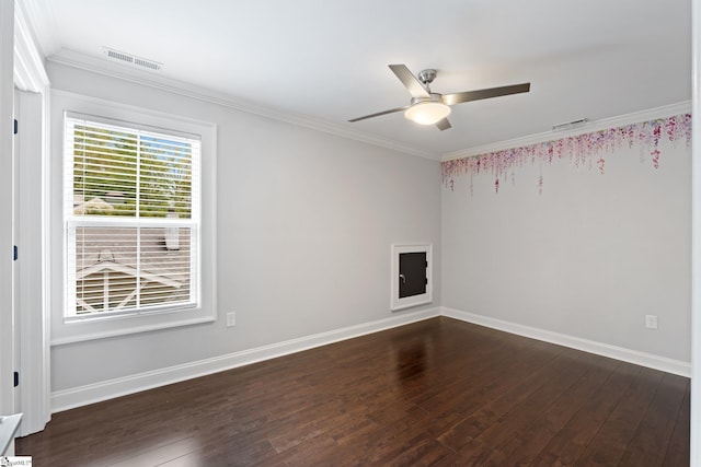 unfurnished room featuring dark wood-style flooring, visible vents, ceiling fan, and crown molding