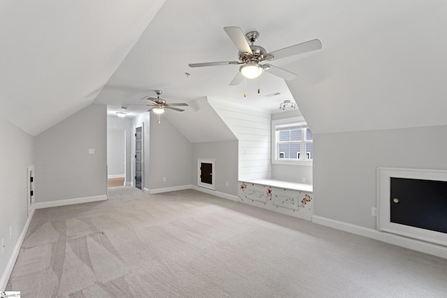bonus room featuring visible vents, baseboards, ceiling fan, vaulted ceiling, and light carpet