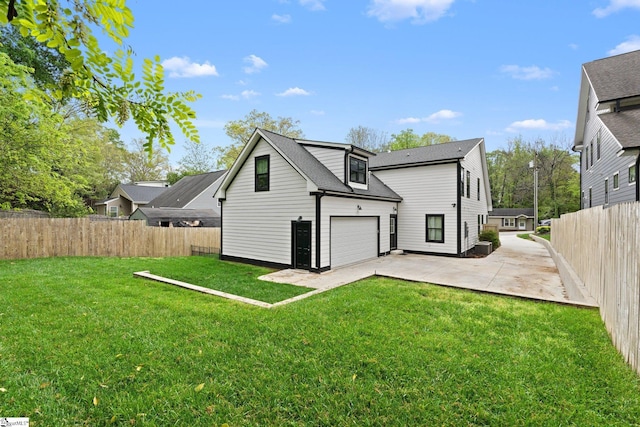 back of house featuring a fenced backyard, a garage, a patio, and a lawn