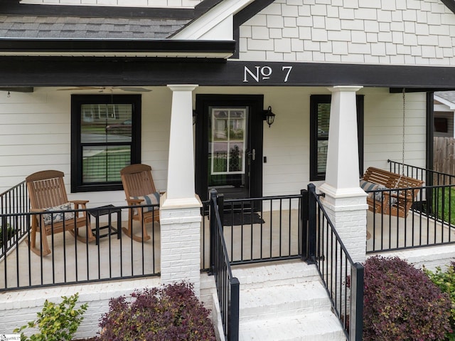 property entrance featuring covered porch and roof with shingles