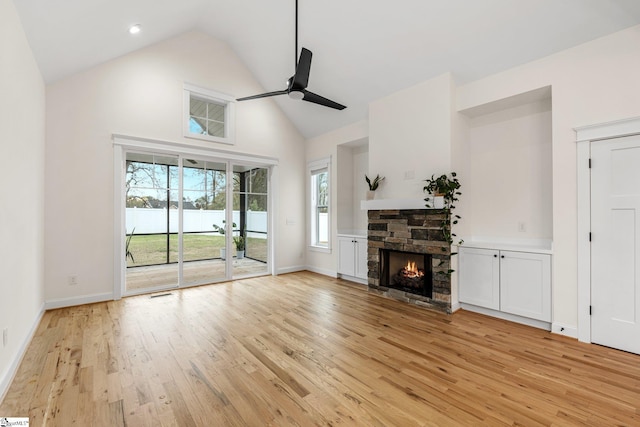 208 Orie Ct, Simpsonville, SC 29680 - unfurnished living room featuring baseboards, a ceiling fan, a fireplace, light wood finished floors, and high vaulted ceiling
