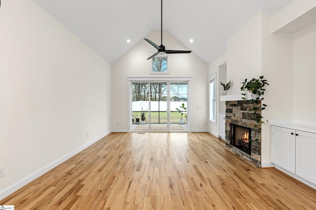 208 Orie Ct, Simpsonville, SC 29680 - unfurnished living room featuring light wood-style floors, high vaulted ceiling, ceiling fan, and a stone fireplace
