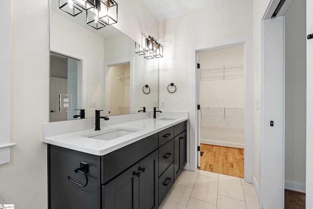 208 Orie Ct, Simpsonville, SC 29680 - bathroom featuring a sink, a spacious closet, marble finish floor, and a notable chandelier