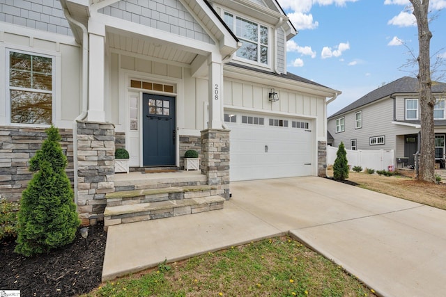 208 Orie Ct, Simpsonville, SC 29680 - entrance to property with board and batten siding, driveway, stone siding, and a garage
